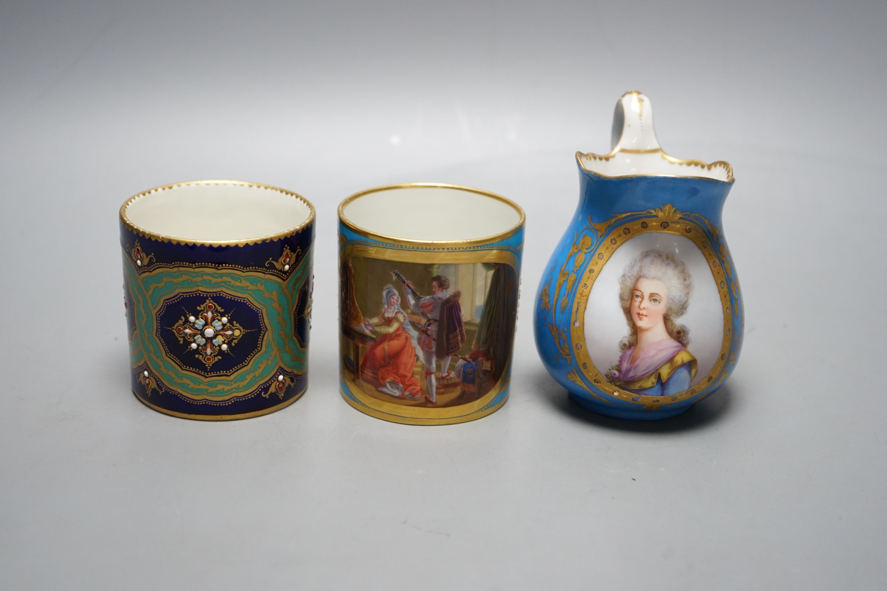 Two Sevres style porcelain coffee cans, cream jug and a cup and saucer, tallest ug 10 cms high.